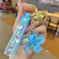 Blue unicorn keychain with floral quicksand bottle, starfish charms and wrist strap - Blue Ocean Petals