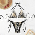 Detailed flat lay of snake print bikini with black ties and stylish beach accessories - Snake Skin Print