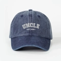 Detailed close-up of UNCLE EST. 2025 white 3D embroidery on navy washed denim baseball cap - Navy Blue