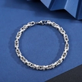 Close-up of a silver stainless steel Cuban link bracelet on a geometric background - Byzantine Emperor Bracelet [Width 5mm] / Length 21cm