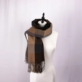 Detail of classic plaid scarf with long tassels showing rich knit cashmere texture - Dark Camel