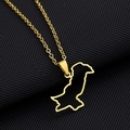 Detailed close-up of a gold-plated Pakistan map hollow pendant on a black textured surface - Hollow Style / Gold