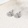 Close-up of silver spiral pendants for DIY jewelry making on a textured background - Spiral Conch / Silver