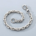 Detailed close-up of stainless steel Cuban link chain with lobster clasp and textured ring - Square Byzantine Chain