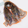 Detail of colorful georgette silk scarf featuring peacock and floral patterns on white background - Orange Fortune Tree