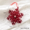 Red flocked snowflake Christmas ornament with sequins on white knitted background - 3D Snowflake