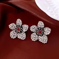 Macro detail of vintage floral earrings with red beads and crystals on brown silk - Bright Silver with White Zirconia