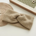 Close-up of khaki knitted twist headband with textured ribbed wool pattern for winter - Khaki