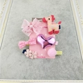 Detailed set of 6 pink children hair clips featuring bows and a giraffe on a display card - Pony Series 6-Piece Set