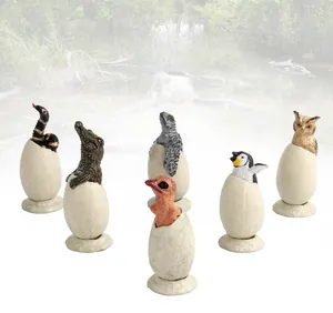Detailed animal egg models showing crocodile, bird, and reptile hatching with display bases