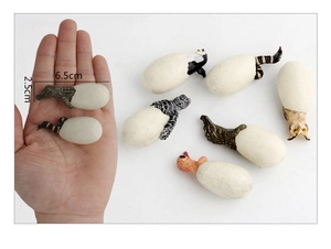 Detailed scale view of miniature hatching animal eggs including penguin and crocodile models