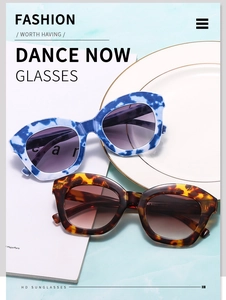 Close-up of trendy cat-eye sunglasses with marble and tortoiseshell frames on a magazine
