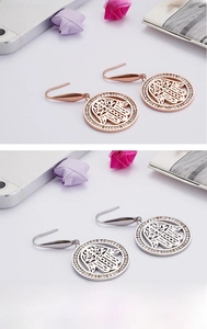 Detail of Hamsa hand earrings in 18K gold plated steel with zircon paving