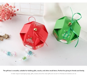 Top view of red and green polygonal Christmas gift boxes with ribbons and small gold bells