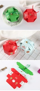 Close-up of colorful Christmas gift boxes with festive ribbons and golden bells decor