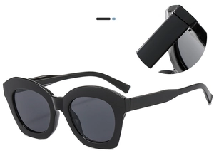 Macro detail of thick black geometric frame and smooth finish on cat-eye sunglasses