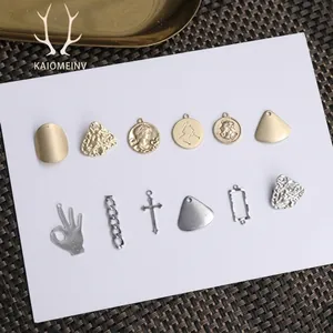 Detailed view of 18K gold plated hollow star and moon pendants with embossed coin patterns