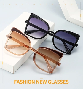 Detail of oversized butterfly sunglasses with gradient lenses on stone display