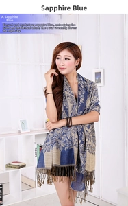 Detail view of royal blue scarf with gold floral jacquard and elegant fringe trim