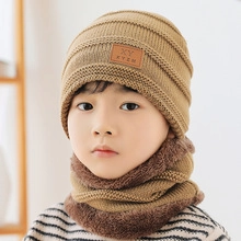 Detail of khaki cable knit hat and neck warmer with thick faux fur lining for kids