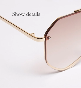 Détail des charnières métalliques et des verres dégradés rose-brun sur lunettes