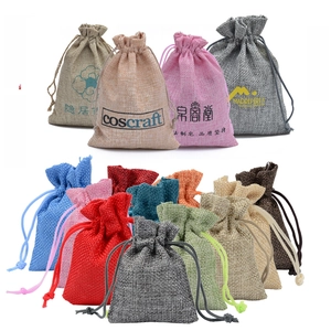 Close-up of multicolored jute drawstring bags showing textured fabric and dual ropes