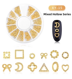 Macro shot of assorted gold hollow metal moon and star nail art studs in a rotating box