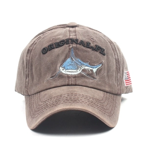 Detail of washed brown cotton baseball cap with shark embroidery and US flag patch