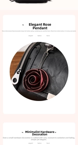 Detail of elegant red leather rose charm and durable silver metal zipper on black handbag