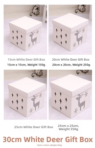 Detailed view of white Christmas gift boxes featuring hollow reindeer and snowflake designs