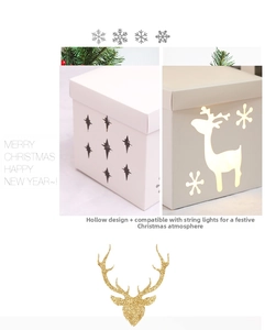 Detail of white Christmas gift box featuring reindeer cutout and glowing light effect