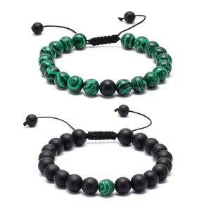 Close-up of adjustable lava and turquoise beaded bracelets with braided cord