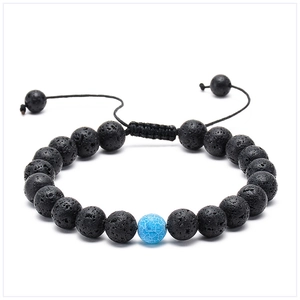 Close-up of lava rock beads and blue crackle stone on adjustable braided bracelet