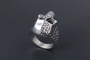 Macro shot of silver titanium ring showing unique textured scale relief and smooth surface