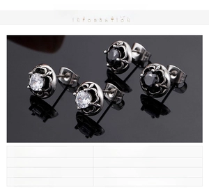 Detail of titanium steel stud earrings with black and white zircon in four-prong settings