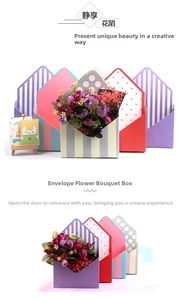 Close-up of envelope-shaped gift boxes with striped and dotted patterns for flower packing