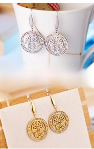 Detailed view of silver Hamsa Hand hook earrings with sparkling rhinestone accents