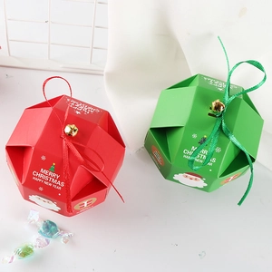 Red and green Christmas candy gift boxes with festive ribbons and small metal bells