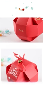 Detailed view of red Christmas gift box with gold bell, ribbon and festive patterns