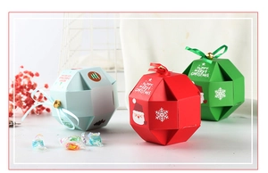 Christmas gift boxes with festive patterns, ribbons, and small bells for holiday candies