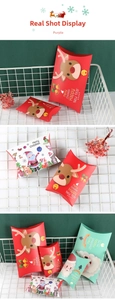 Close-up of festive Christmas reindeer pillow candy boxes in decorative white iron basket