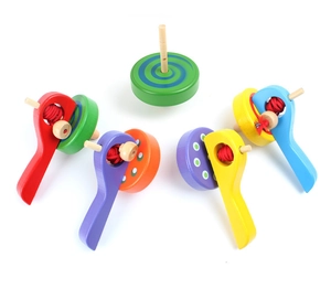Detailed view of colorful wooden spinning tops with pull-cord handles in various colors