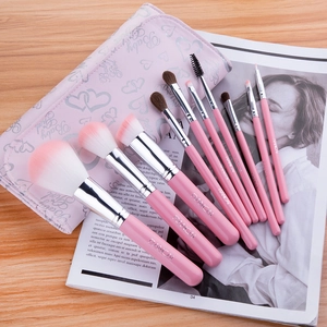 Professional 10pcs pink makeup brush set with heart pattern pouch on stylish wooden desk