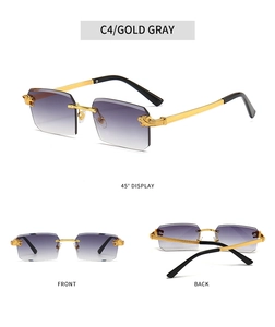 Detail view of rimless gradient sunglasses with gold lion head hardware and black tips