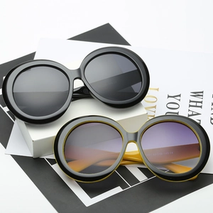 Oversized round vintage sunglasses for men and women on a white minimalist background