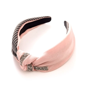 Pink and striped fabric knot headband featuring a central sparkling rhinestone embellishment