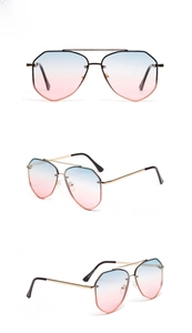 Detail view of gold metal pilot sunglasses with blue and pink gradient lenses