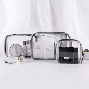 Three-piece transparent PVC travel makeup bag set with gray trim and zipper closure