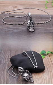 Detailed macro view of gothic steampunk skull pendant with mechanical gears and twist chain
