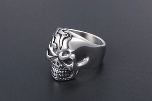 Macro shot of silver metal skull ring with vintage distressed finish details